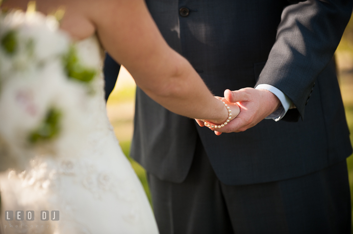 Bride and Groom holding each other's hands. Kent Island Maryland Matapeake Beach wedding ceremony and getting ready photo, by wedding photographers of Leo Dj Photography. http://leodjphoto.com