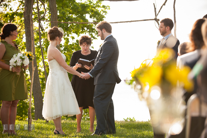 Bride, Groom and officiant under open wooden canopy. Kent Island Maryland Matapeake Beach wedding ceremony and getting ready photo, by wedding photographers of Leo Dj Photography. http://leodjphoto.com