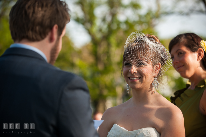 Bride smiling listening to Groom's vow. Kent Island Maryland Matapeake Beach wedding ceremony and getting ready photo, by wedding photographers of Leo Dj Photography. http://leodjphoto.com