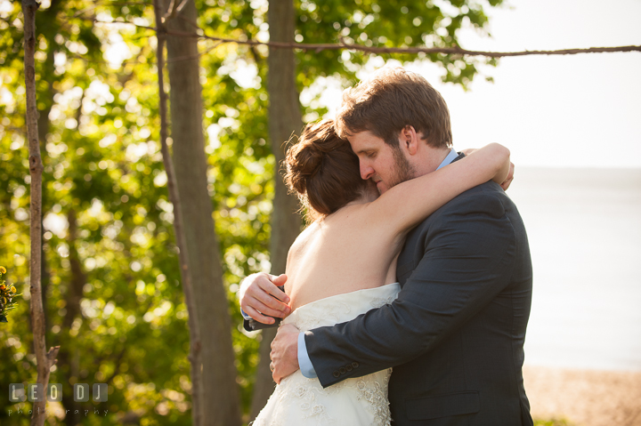 Bride and Groom hugged each other after they are officially married. Kent Island Maryland Matapeake Beach wedding ceremony and getting ready photo, by wedding photographers of Leo Dj Photography. http://leodjphoto.com