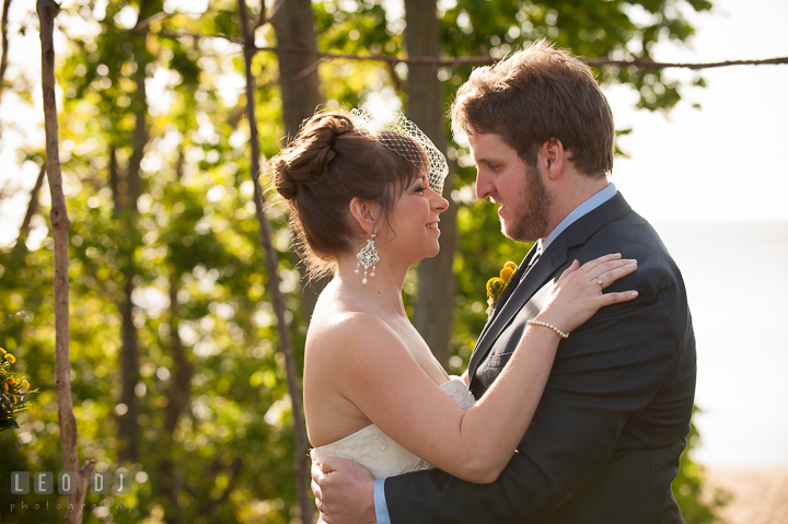 Bride and Groom holding each other close. Kent Island Maryland Matapeake Beach wedding ceremony and getting ready photo, by wedding photographers of Leo Dj Photography. http://leodjphoto.com