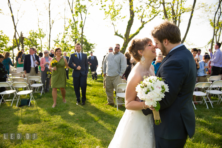 Bride and Groom smiled and almost kissed as they walk out of the isle. Kent Island Maryland Matapeake Beach wedding ceremony and getting ready photo, by wedding photographers of Leo Dj Photography. http://leodjphoto.com