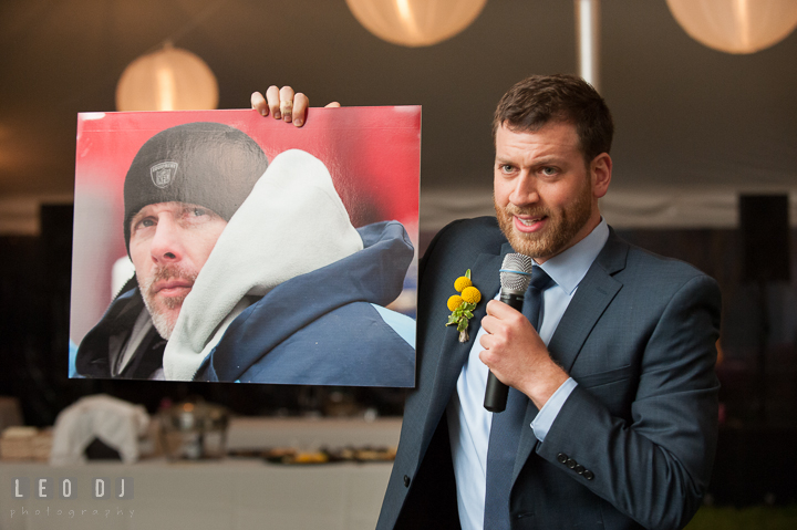 Best Man showing picture of NFL player Kerry Collins to guests during his toast speech. Kent Island Maryland Matapeake Beach wedding reception party and romantic session photo, by wedding photographers of Leo Dj Photography. http://leodjphoto.com