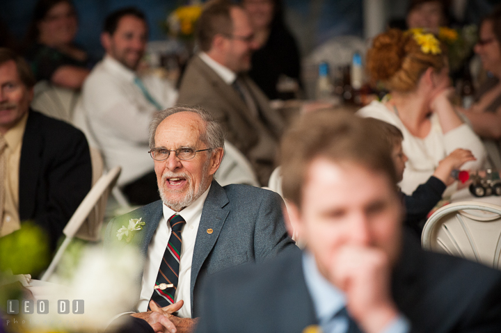 Groom's Grandfather laughing listening to toast speech. Kent Island Maryland Matapeake Beach wedding reception party and romantic session photo, by wedding photographers of Leo Dj Photography. http://leodjphoto.com