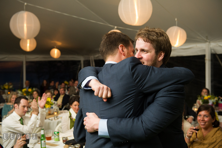 Groom hugged Best man after toast speech. Kent Island Maryland Matapeake Beach wedding reception party and romantic session photo, by wedding photographers of Leo Dj Photography. http://leodjphoto.com