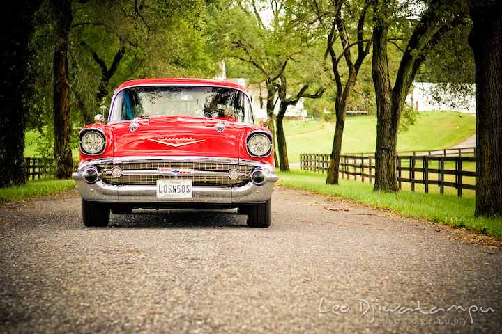 Engaged couple driving antique car. Pre-wedding engagement photography session old antique Chevy Bel Air car, dress, outfit, accessories, suitcases