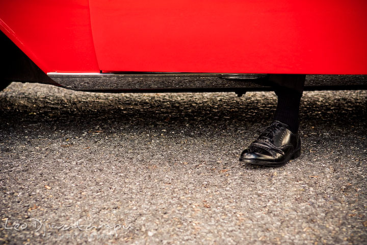 Engaged guy stepping out of his vehicle. Pre-wedding engagement photography session old antique Chevy Bel Air car, dress, outfit, accessories, suitcases