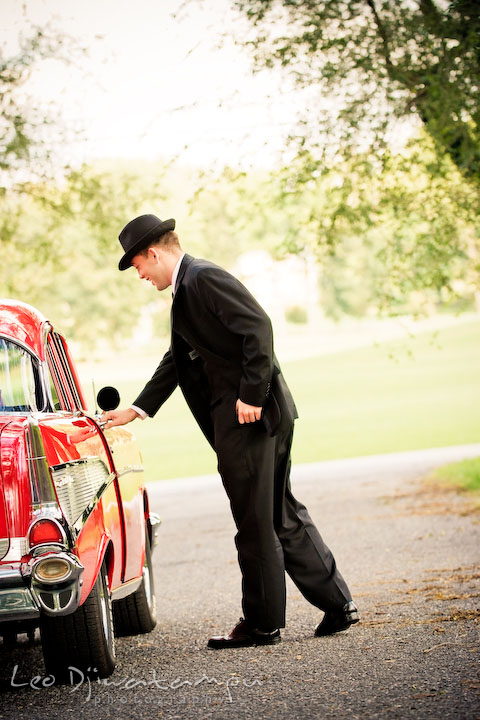 Engaged gentleman opening the door for his fiancee. Pre-wedding engagement photography session old antique Chevy Bel Air car, dress, outfit, accessories, suitcases