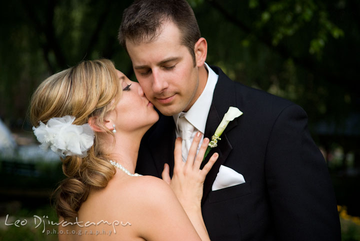 Bride kissed groom during romantic session. Turf Valley, Ellicott City, Maryland wedding photos by photographers of Leo Dj Photography