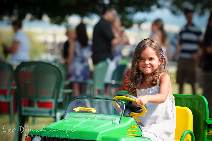 little girl playing and driving small John Deere car truck. Cove Creek Country Club, Stevensville, Kent Island, Eastern Shore, Maryland Wedding Photographer, beach wedding photographer