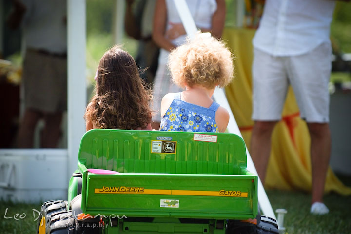 two girls driving small John Deere truck. Cove Creek Country Club, Stevensville, Kent Island, Eastern Shore, Maryland Wedding Photographer, beach wedding photographer