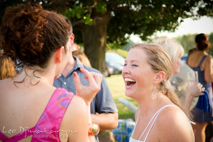 Bride laughing with another guest. Cove Creek Country Club, Stevensville, Kent Island, Eastern Shore, Maryland Wedding Photographer, beach wedding photographer