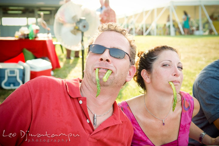 Two guests goofing around, hanging asparagus from their mouth. Cove Creek Country Club, Stevensville, Kent Island, Eastern Shore, Maryland Wedding Photographer, beach wedding photographer