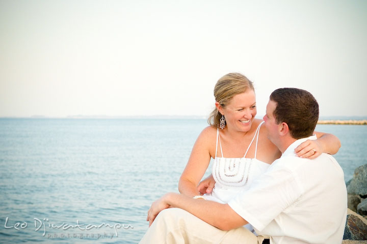 Bride and groom sitting on the rocks by the beach. Cove Creek Country Club, Stevensville, Kent Island, Eastern Shore, Maryland Wedding Photographer, beach wedding photographer