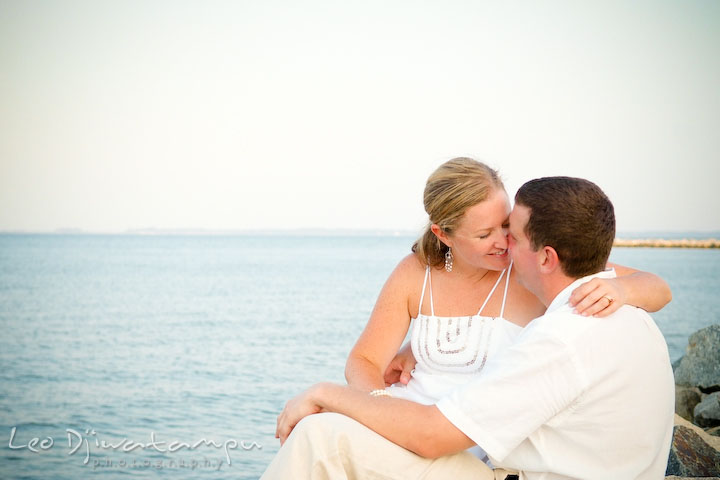 Bride and groom almost kiss, on the rocks on the beach. Cove Creek Country Club, Stevensville, Kent Island, Eastern Shore, Maryland Wedding Photographer, beach wedding photographer