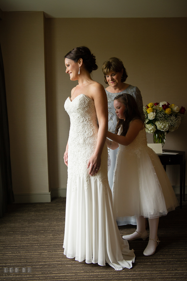 Westin Annapolis Hotel daughter and mother buttoning up bride's gown photo by Leo Dj Photography