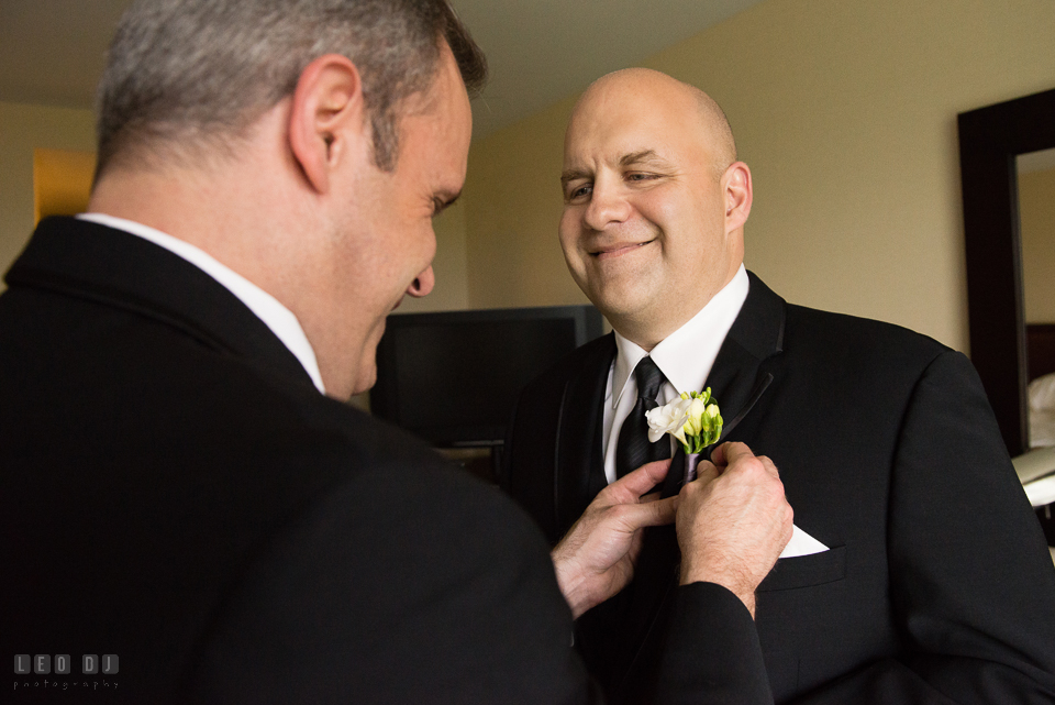 Westin Annapolis Hotel best man put boutonniere on groom photo by Leo Dj Photography