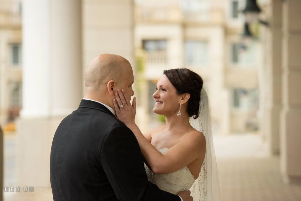 Westin Annapolis Hotel bride happy and holding groom's face during first look photo by Leo Dj Photography