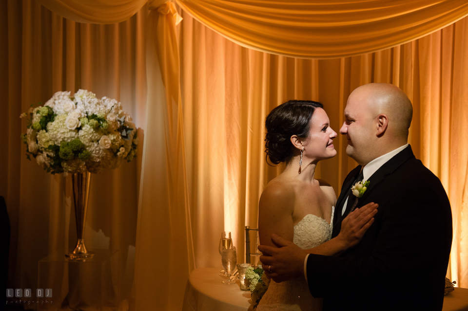 Westin Annapolis Hotel bride and groom cuddling by sweetheart table photo by Leo Dj Photography