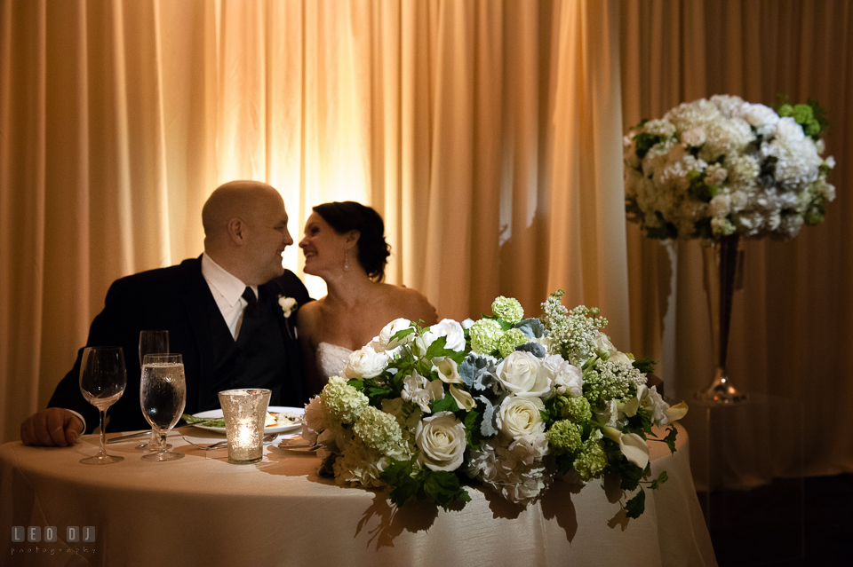 Westin Annapolis Hotel bride and almost kissed by sweetheart table with flowers from Blue Vanda Designs photo by Leo Dj Photography