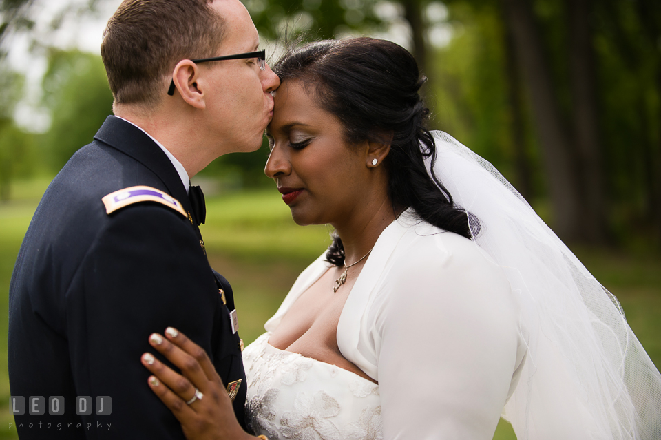 Groom kissing Bride's forehead. Aspen Wye River Conference Centers wedding at Queenstown Maryland, by wedding photographers of Leo Dj Photography. http://leodjphoto.com