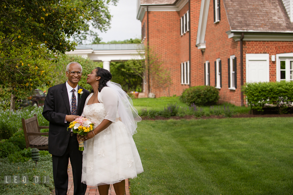 Bride kissing her father as they were walking toward the ceremony site. Aspen Wye River Conference Centers wedding at Queenstown Maryland, by wedding photographers of Leo Dj Photography. http://leodjphoto.com