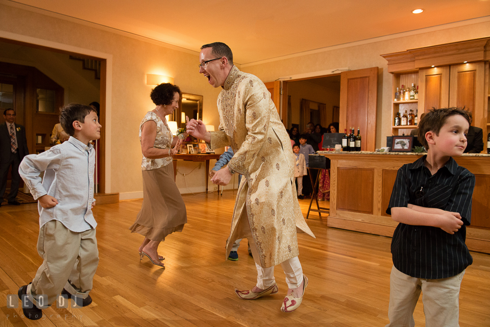 Groom dancing energetically with few kids during Mother of the Groom and son dance. Aspen Wye River Conference Centers wedding at Queenstown Maryland, by wedding photographers of Leo Dj Photography. http://leodjphoto.com