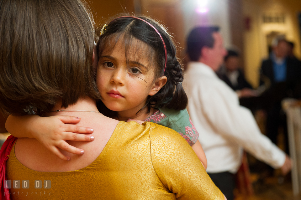 Girl cuddled with mom and looking at the camera. Aspen Wye River Conference Centers wedding at Queenstown Maryland, by wedding photographers of Leo Dj Photography. http://leodjphoto.com