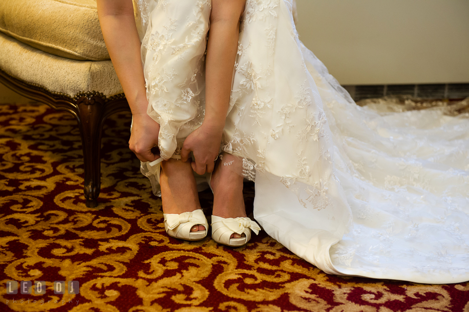 Bride tying up her wedding shoes. Tremont Grand Historic Venue wedding, Baltimore, Maryland, by wedding photographers of Leo Dj Photography. http://leodjphoto.com