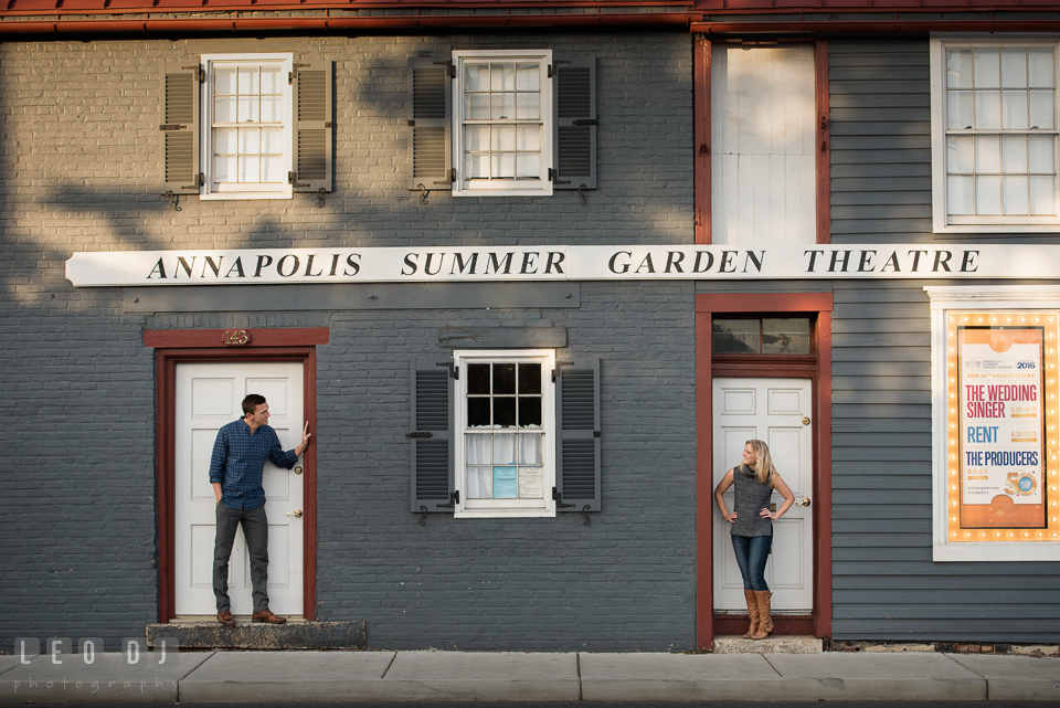 Downtown Annapolis Maryland engaged couple looking at each other in front of Annapolis Summer Garden Theatre photo by Leo Dj Photography.