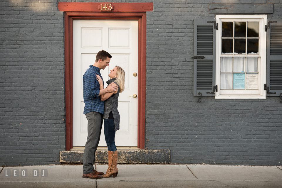 Downtown Annapolis Maryland engaged couple hugging in front of the Summer Garden Theater photo by Leo Dj Photography.