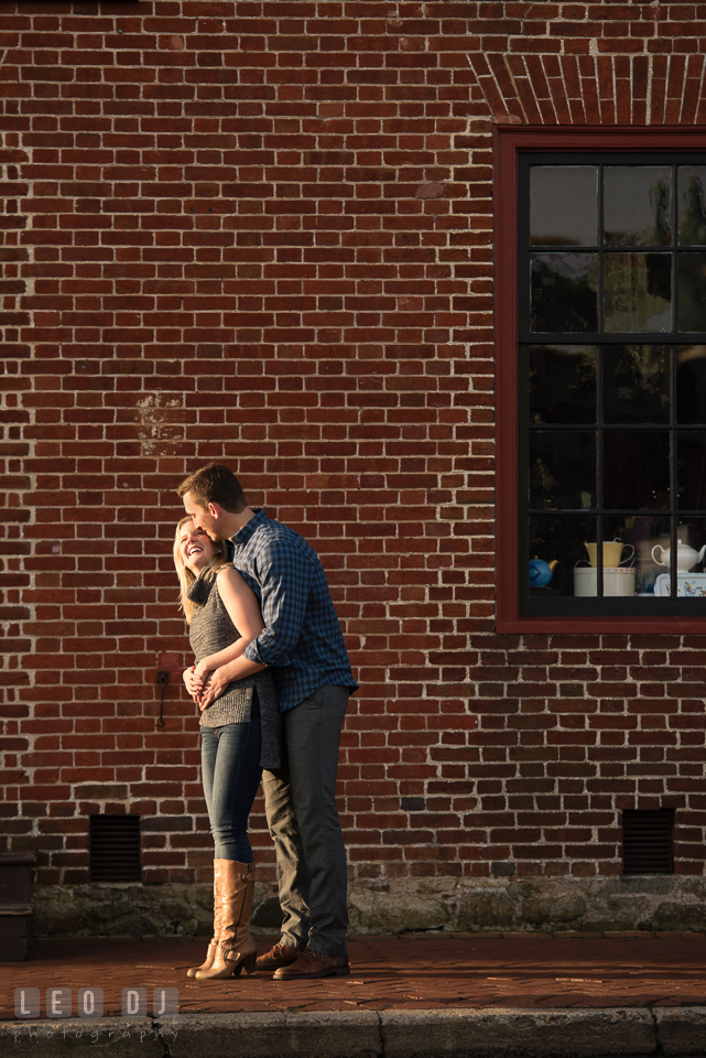 Downtown Annapolis Maryland engaged guy hugging his fiancee and laughing photo by Leo Dj Photography.