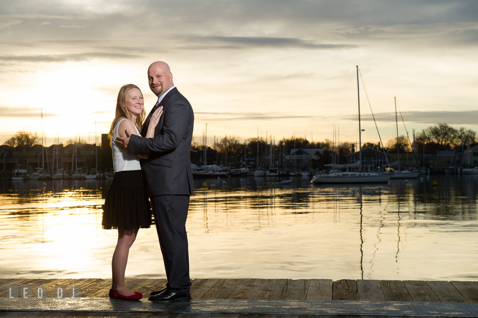 Downtown Annapolis Maryland engaged couple posing on boat dock photo by Leo Dj Photography.