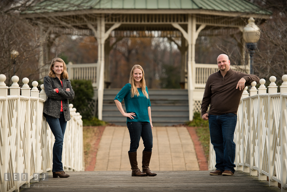 Quiet Waters Park Annapolis Maryland engaged girl with daughter and fiance posing on the bridge photo by Leo Dj Photography.