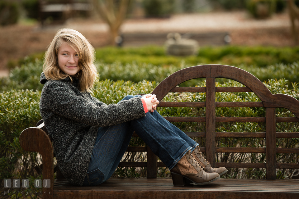 Quiet Waters Park Annapolis Maryland daughter of engaged couple lounging on bench photo by Leo Dj Photography.