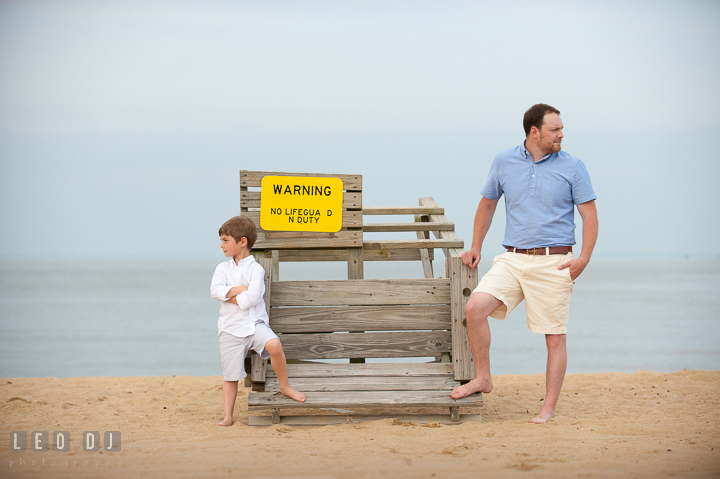 Father and son posing by a lifeguard post chair. Chesapeake Bay, Kent Island, Annapolis, Eastern Shore Maryland children and family lifestyle portrait photo session by photographers of Leo Dj Photography. http://leodjphoto.com