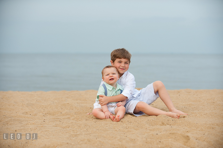 Big brother giving hug to little baby brother. Chesapeake Bay, Kent Island, Annapolis, Eastern Shore Maryland children and family lifestyle portrait photo session by photographers of Leo Dj Photography. http://leodjphoto.com