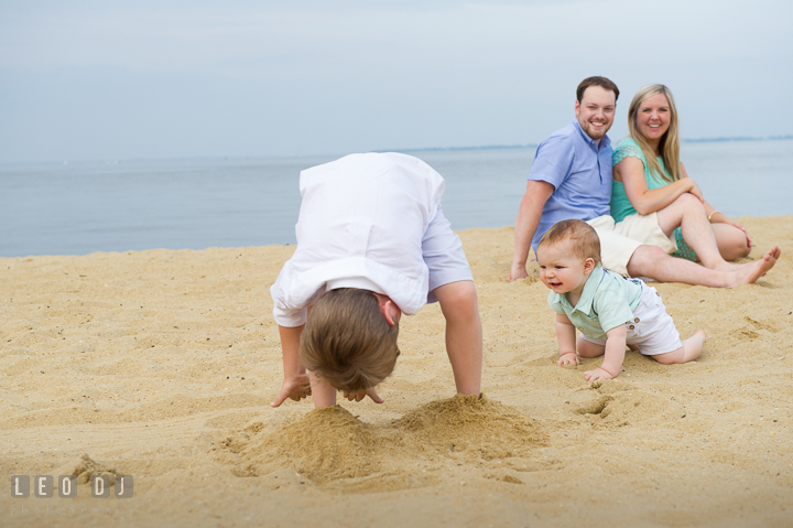 Big brother playing peek-a-boo with baby brother. Chesapeake Bay, Kent Island, Annapolis, Eastern Shore Maryland children and family lifestyle portrait photo session by photographers of Leo Dj Photography. http://leodjphoto.com