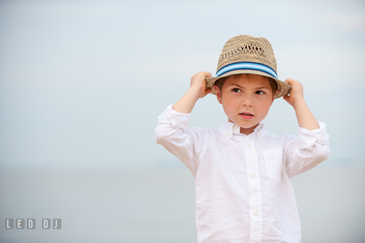 Young boy posing and holding his fedora hat. Chesapeake Bay, Kent Island, Annapolis, Eastern Shore Maryland children and family lifestyle portrait photo session by photographers of Leo Dj Photography. http://leodjphoto.com