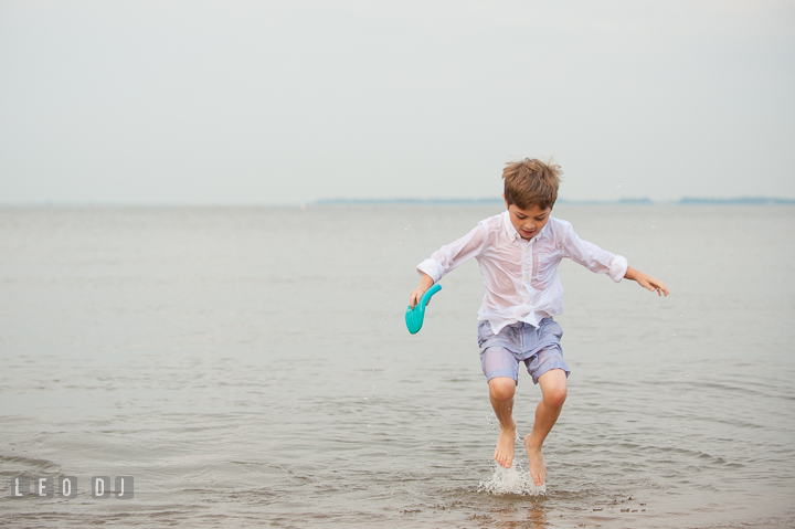 Young boy jumping on the water. Chesapeake Bay, Kent Island, Annapolis, Eastern Shore Maryland children and family lifestyle portrait photo session by photographers of Leo Dj Photography. http://leodjphoto.com