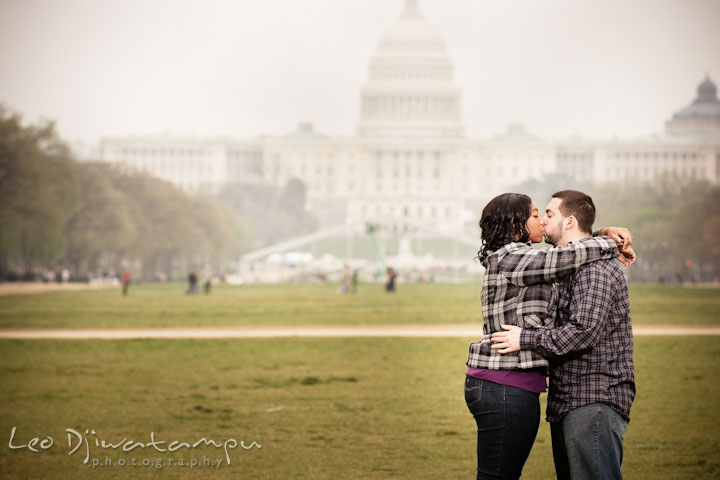 Engaged couple kissing by the Capitol building. Pre wedding engagement photo session the Mall, National Monument, The Capitol, Washington DC by wedding photographer Leo Dj Photography