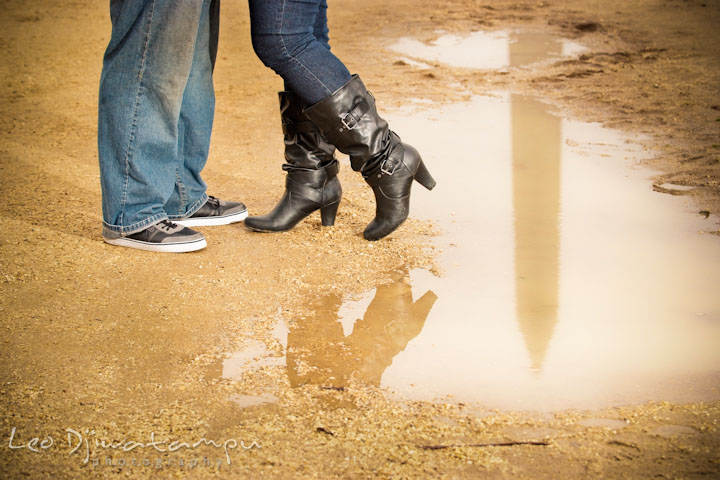 Engaged couple shoes by a reflection of the National Monument on a water. Pre wedding engagement photo session the Mall, National Monument, The Capitol, Washington DC by wedding photographer Leo Dj Photography