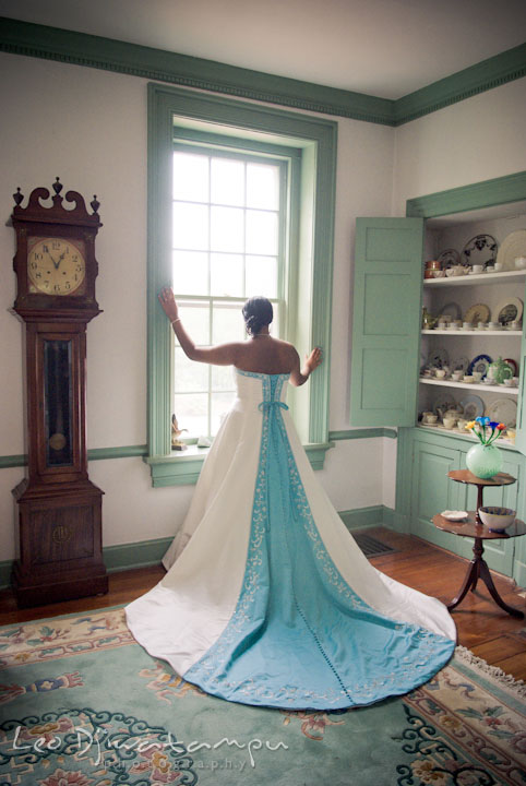 Bride posing by window showing beautiful wedding dress. Kitty Knight House Georgetown Maryland wedding photos by photographers of Leo Dj Photography.