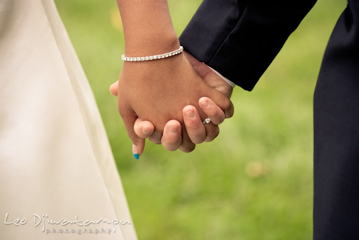 Bride and groom holding hands. Kitty Knight House Georgetown Maryland wedding photos by photographers of Leo Dj Photography.