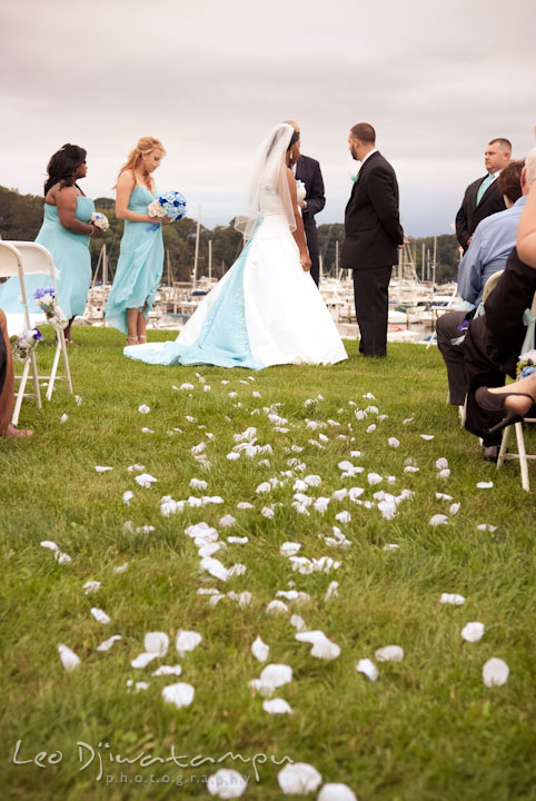 Flower petals on ground leading to bride, groom and wedding party at ceremony. Kitty Knight House Georgetown Maryland wedding photos by photographers of Leo Dj Photography.