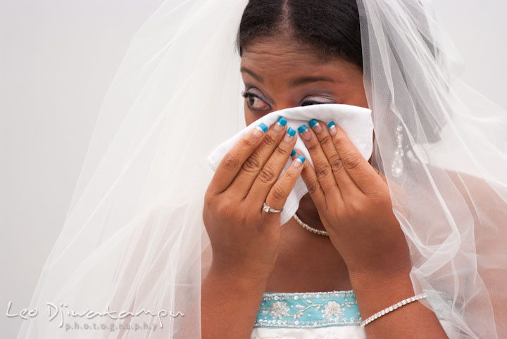 Bride wiping tears from eyes. Kitty Knight House Georgetown Maryland wedding photos by photographers of Leo Dj Photography.