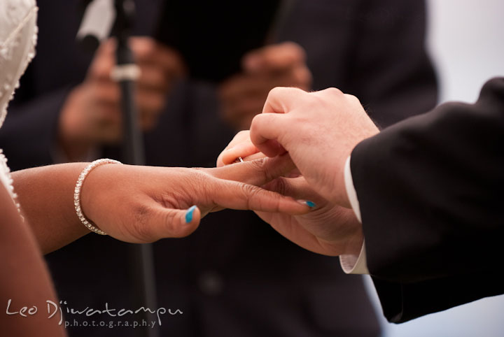 Groom put ring on bride. Kitty Knight House Georgetown Maryland wedding photos by photographers of Leo Dj Photography.