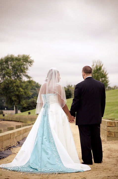 Bride and groom holding hands. Kitty Knight House Georgetown Maryland wedding photos by photographers of Leo Dj Photography.