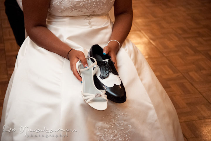 Bride holding shoes for the shoe game. Kitty Knight House Georgetown Maryland wedding photos by photographers of Leo Dj Photography.