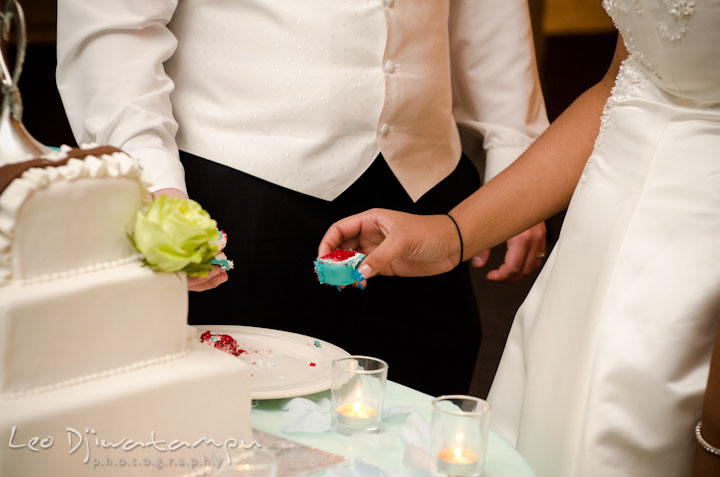 Bride and groom holding wedding cake. Kitty Knight House Georgetown Maryland wedding photos by photographers of Leo Dj Photography.